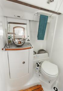 a small bathroom with a toilet and a sink at BBoats in Lisbon
