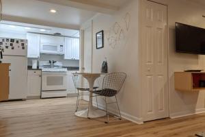 a kitchen with a table and chairs in a room at Retro suite with separate office walking- distance to downtown Silver Spring! in Silver Spring
