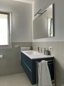 a bathroom with a sink and a mirror at Le due sorelle - LUCI in Civitanova Marche