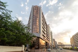 a rendering of a tall building on a city street at City Palace Hotel in Dubai