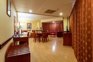 a living room with a table and a dining room at City Palace Hotel in Dubai