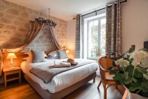 Postel nebo postele na pokoji v ubytování Hôtel Le Pré Galoffre