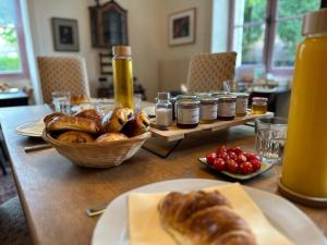 a table with a plate of bread and a basket of food at Villa Vallière bed&breakfast in Vallières