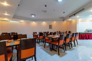 a dining room with tables and chairs in it at City Palace Hotel in Dubai