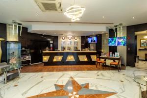 a lobby with a star on the floor at City Palace Hotel in Dubai