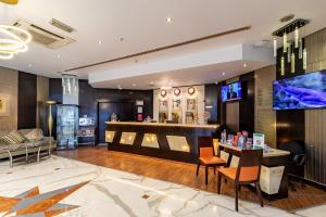 a lobby of a hotel with a counter and chairs at City Palace Hotel in Dubai