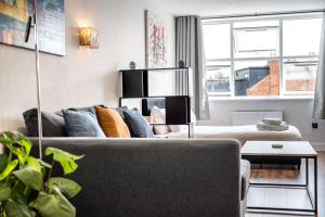 a living room with a couch and a table at 2 - West London Brand New Loft in London