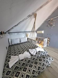 a bedroom with a bed with white bows on it at Penthouse Apartments PERLA, Vasiliko in Tsarevo