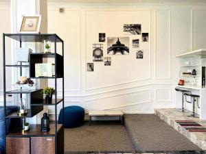 a room with a white wall with pictures on the wall at Skyline BlueDome Villa Ciwidey in Ciwidey