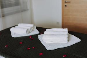 three towels on a bed with red hearts on it at MY HOME ADDL in Štrigova