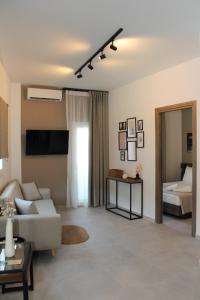 a living room with a couch and a bed at UrbanBay Hotel & Spa in Kavala