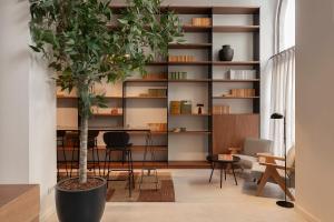 a living room with a tree and a table at TOC Hotel Las Ramblas in Barcelona