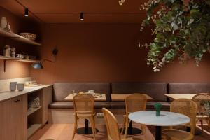 a restaurant with a couch and tables and chairs at TOC Hotel Las Ramblas in Barcelona