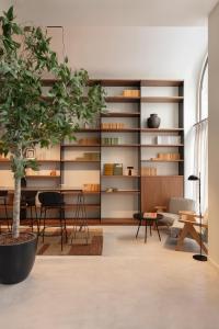 a living room with a table and a potted tree at TOC Hotel Las Ramblas in Barcelona