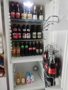 d'un réfrigérateur rempli de nombreuses bouteilles de soda. dans l'établissement B&B Emmylou, à Gouvy