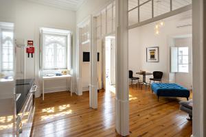 a living room with a blue couch and a table at Alagoa Apartments in Tavira