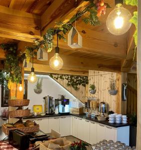 a kitchen with wooden ceilings and lights and a counter at Centrum Trzy Jeziora Wieleń in Wielen Zaobrzanski