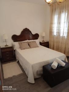 a bedroom with a large white bed and two night stands at Casa Rural Chorrito 1 in La Alberca
