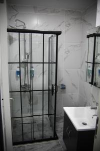 a bathroom with a glass shower and a sink at The Hera Bostancı in Istanbul