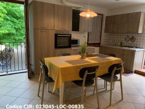 a kitchen with a table and chairs in a room at Hotel Dolomiti in Malcesine