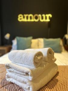 a pile of towels sitting on top of a bed at Unique Clifton apartment on historic crescent in Bristol