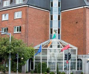 a building with flags on the front of it at Leonardo Hotel Cork - Formerly Jurys Inn in Cork
