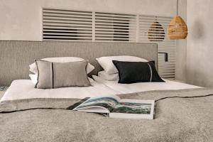 a bedroom with a bed with a book on it at GRANO HOTEL Solmarina in Wiślinka