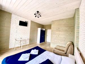 a bedroom with a bed and a chair and a table at Friends house bukovel in Bukovel