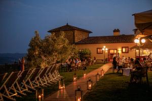 a group of people sitting in chairs in front of a building at Tenuta di Artimino member of Meliá Collection in Artimino