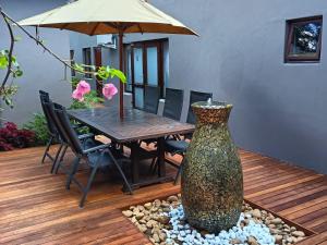 a patio with a table and a vase in the middle at 37 On Anderson in Pretoria