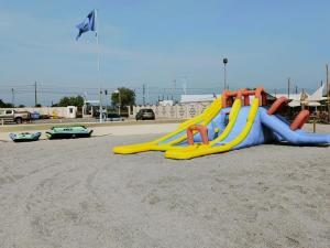 a playground with a slide in the sand at Vila Plaja Azur in Eforie Nord