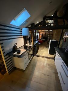 a kitchen and living room with a loft at Loft i gemelli in Montbéliard