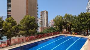 a swimming pool in a city with tall buildings at DON MIGUEL sea view apartment in Benidorm