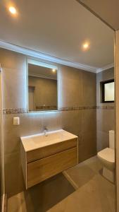 a bathroom with a sink and a toilet at Serenity Place Garden View in Durban