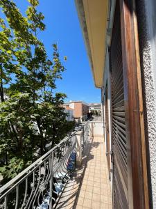 a balcony with a row of benches on a building at Il Sogno in Senigallia