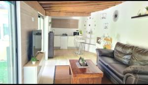 a living room with a couch and a table at Casita Sarabia in Ponteareas