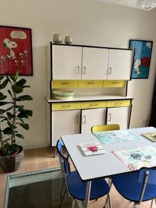 a kitchen with a table and a table and chairs at Huis Agnes in Ostend