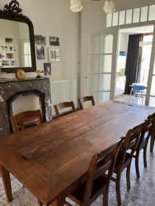 a large wooden table in a room with a fireplace at Huis Agnes in Ostend