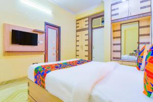 a bedroom with a large bed and a tv at FabHotel The Grand Kailash in Jaipur