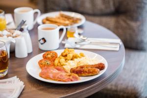 a plate of breakfast food on a table at AC Hotel by Marriott Birmingham in Birmingham