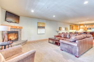 a living room with couches and a fireplace at #101 Grand Lodge South Master Suite in Government Camp +16 photos