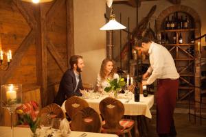 a group of people sitting around a table in a restaurant at Hotel Comfort Erica Dolomiti Val d'Adige in Salorno +106 photos