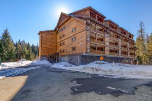 a large wooden building on the side of a road at #101 Grand Lodge South Master Suite in Government Camp
