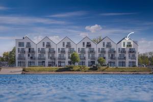 a rendering of a large apartment building from the water at Sehliebe in Olpenitz