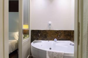 A bed or beds in a room at Smy Bologna Centrale