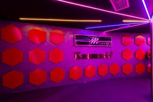 a room with a neon sign with hearts on the wall at City Palace Hotel in Dubai