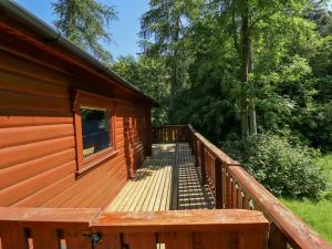 a wooden deck on the side of a cabin at 64 Acorn Lodge Kenwick Park in Louth