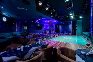 a dance floor in a ballroom with tables and chairs at City Palace Hotel in Dubai