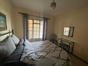 a bedroom with a bed and a window at Pendleberry Holiday Resort - Unit 41 in Bela-Bela