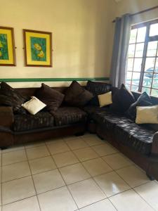 a brown leather couch in a living room at Pendleberry Holiday Resort - Unit 41 in Bela-Bela